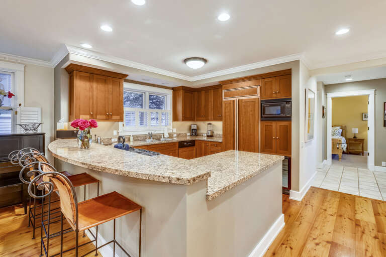 Open kitchen has state of the art appliances and wine cooler