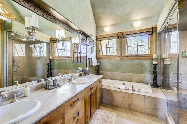 Large main master bathroom with double vanities, jetted tub, and a large walk-in steam shower.