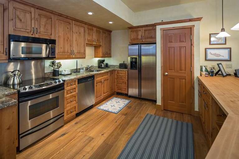 Kitchen with new butcher block counter and all new kitchen ware.