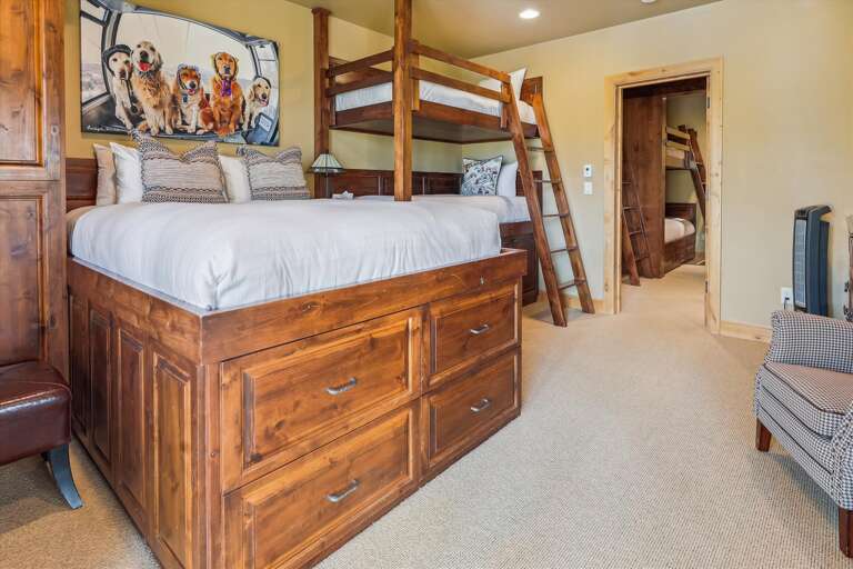 Lowest Level - 5th bedroom with Queen bed and two Twin bunks. Just outside is the hot tub and fire table.