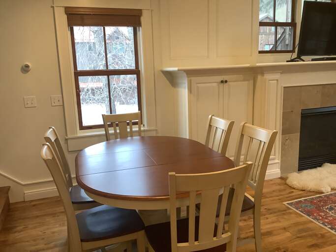 Dining area with seating for 6 near the fireplace.