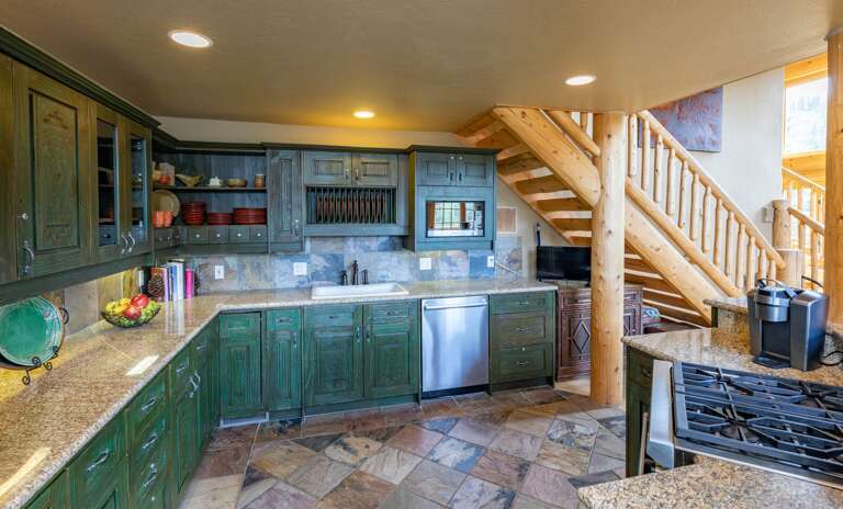Well stocked kitchen with high-end appliances overlooking living and dining area. Well stocked kitchen with high-end appliances overlooking living and dining area.