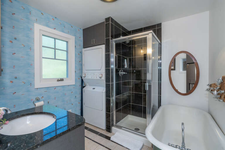 Includes shower, claw foot bathtub, toilet, sink and stacked full size washer/dryer.