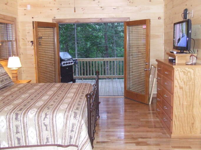 The bedroom on the Main Floor offers a King Size bed with access to the covered fromt porch.