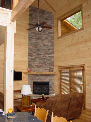 As you enter the front door you will be drawn to the beautiful towering stone gas log fireplace.
