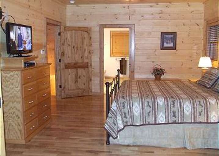 THE MAIN LEVEL BEDROOM ALSO HAS IT'S OWN PRIVATE BATHROOM WITH A FLATSCREEN TV AND ACCESS TO THE COVERED DECK.