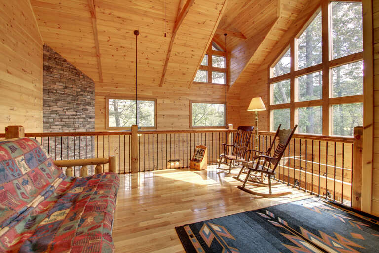 A VIEW FROM THE OPEN AIR LOFT AREA OFFERS YOU A WALL OF WINDOWS WHILE SPENDING QUIET TIME IN THE LOFT YOU CAN ENJOY A BEAUTIFUL MOUNTAIN VIEW