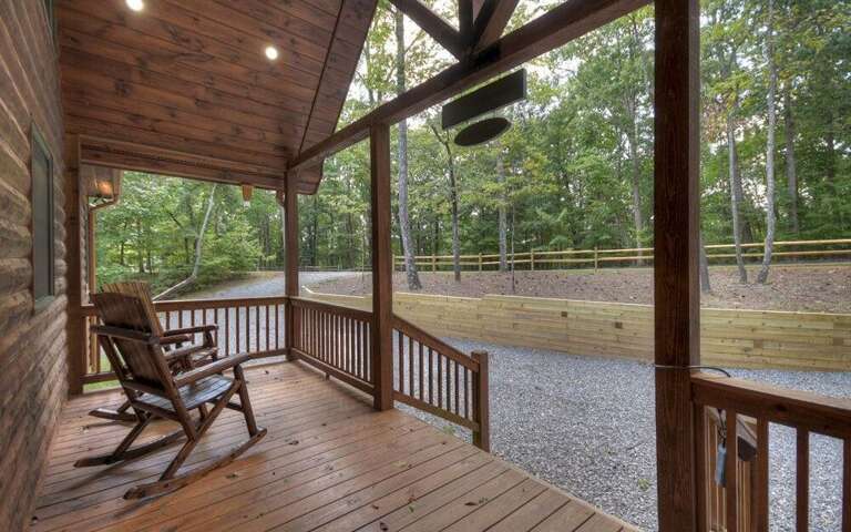 Wooden Deck With Rocking Chair Overlooking Fenced Area