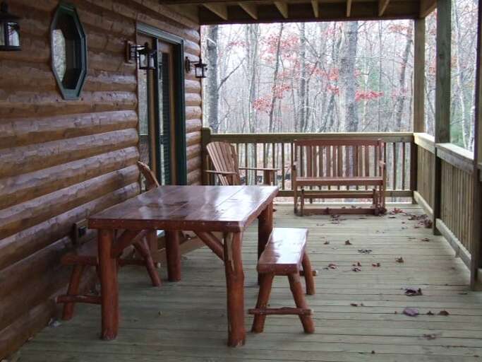The back deck has a table to enjoy dinner.