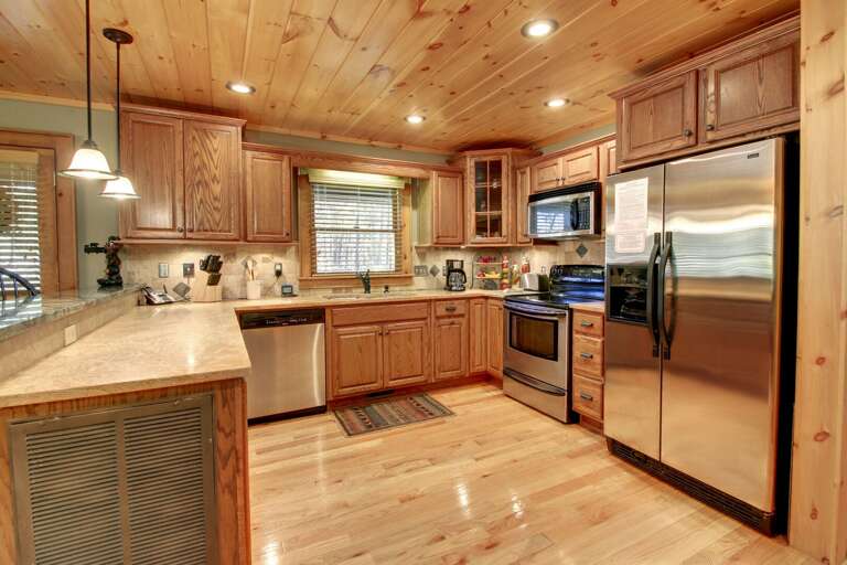 The spacious kitchen is equipped with Stainless Steel Appliances. Bar provides seating for 2 the counter tops are cultured marble with custom tile backsplashes.