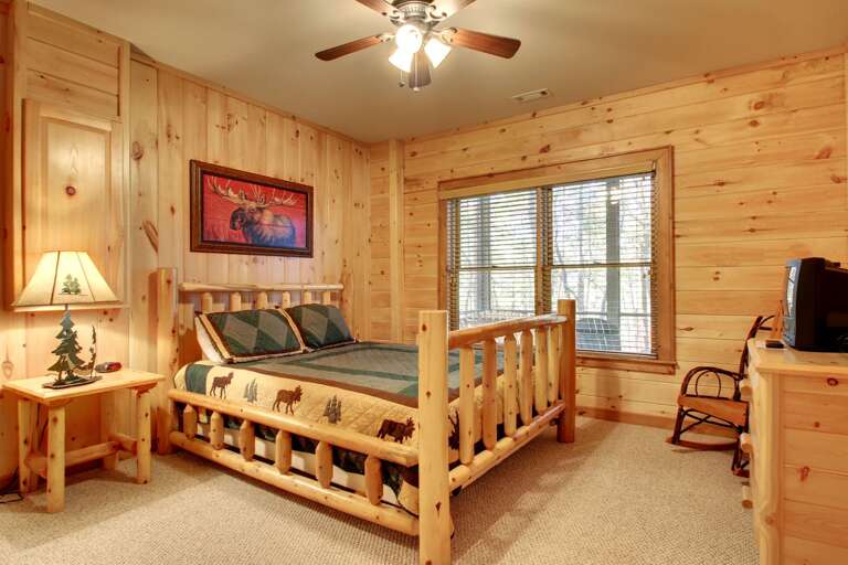 Downstairs Bedroom offers a Queen Bed and TV with a playstation for your children to enjoy Downstairs Bedroom offers a Queen Bed and TV with a playstation for your children to enjoy