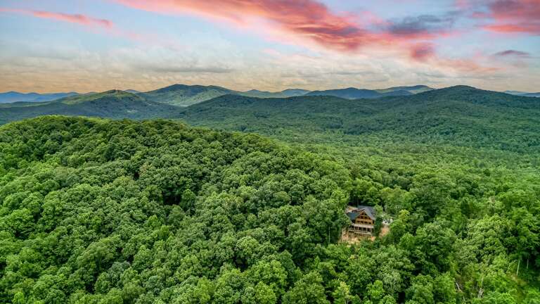 Secluded Building Surrounded By Forest With Sunset Sky