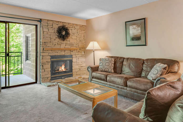 Living Room With Fireplace And Sofa Near Open Patio Door Living Room With Fireplace And Sofa Near Open Patio Door