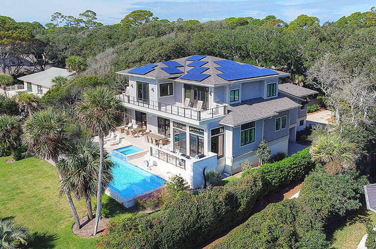 Blue-roofed Vacation Rental Nestled In Verdant Vegetation With Pool