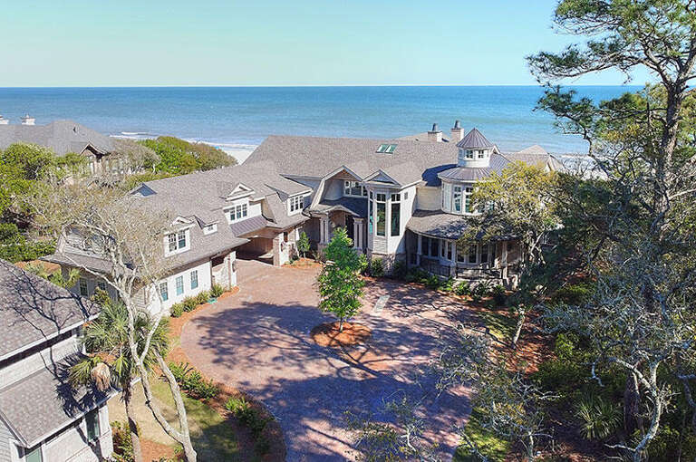 Large Seaside Residence Nestled Between Lush Trees With Ocean Backdrop