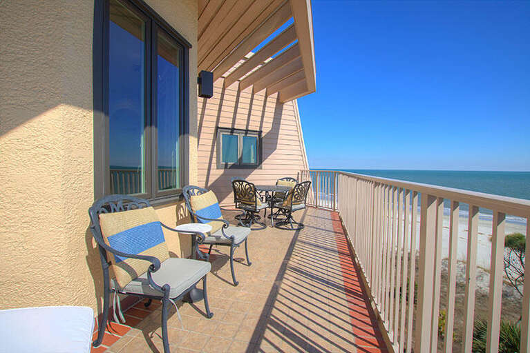 Beachside Balcony With Chairs Overlooking The Ocean