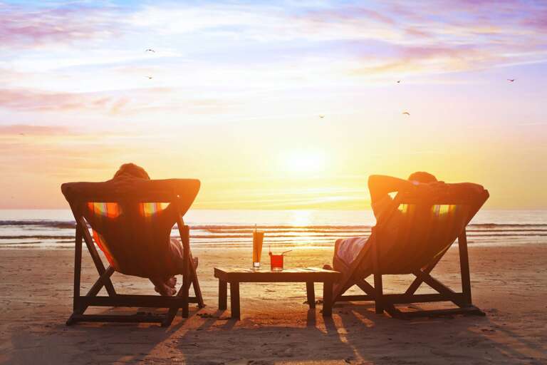 Sunset Scene With Seated Silhouettes Savoring Seaside Serenity