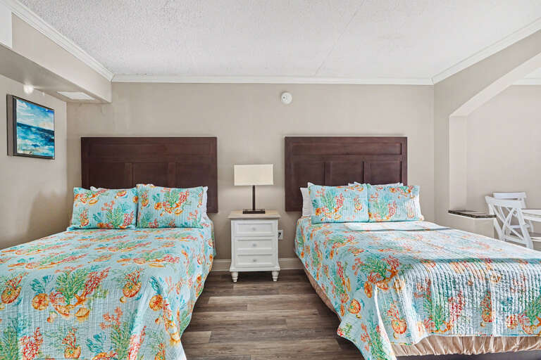 Room With Twin Beds, Bright Bedspreads, Beach-themed Decor