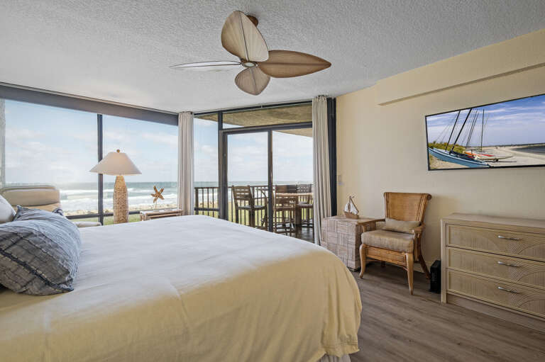 Watch your favorite shows on the mounted TV while enjoying the beautiful New Smyrna Beach view from the comfort of the master bedroom's king bed