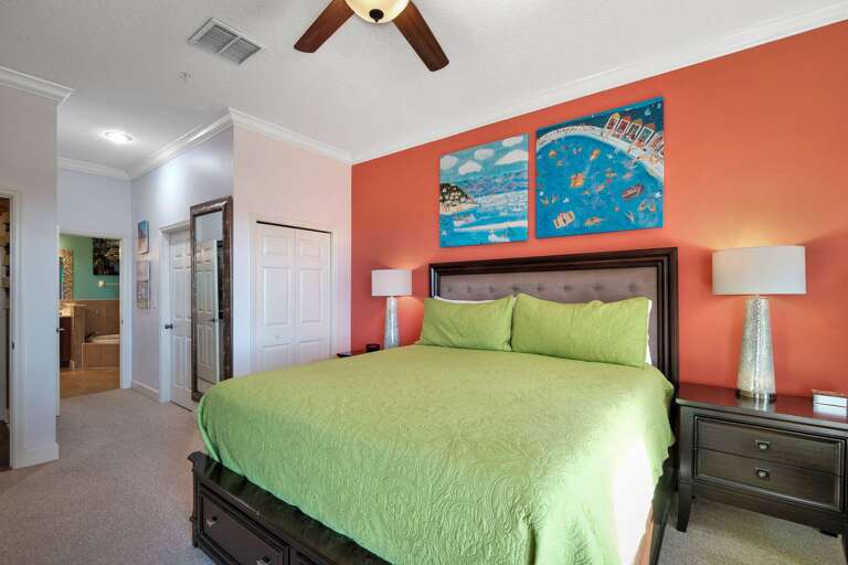 Master bedroom featuring a king bed and a private ensuite bathroom Master bedroom featuring a king bed and a private ensuite bathroom