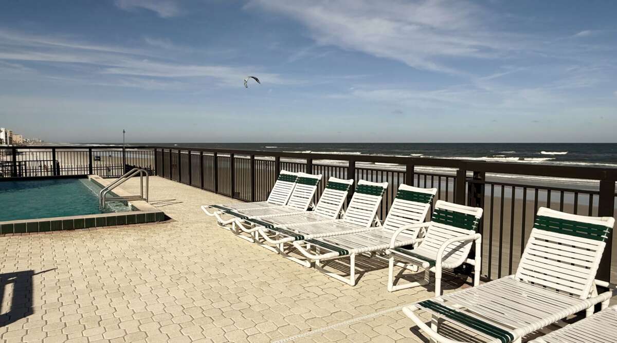 Chairs on the beachfront pool deck, perfect for soaking up the sun while listening to the soothing ocean waves Chairs on the beachfront pool deck, perfect for soaking up the sun while listening to the soothing ocean waves