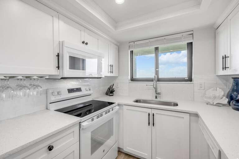 Fully equipped kitchen stocked with everything you need for your vacay, including wine glasses for vino lovers