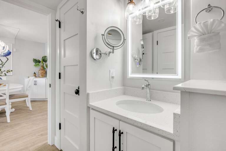 Gorgeous bathroom with luxurious touches, including a full-size and smaller magnifying mirror, both with lighting