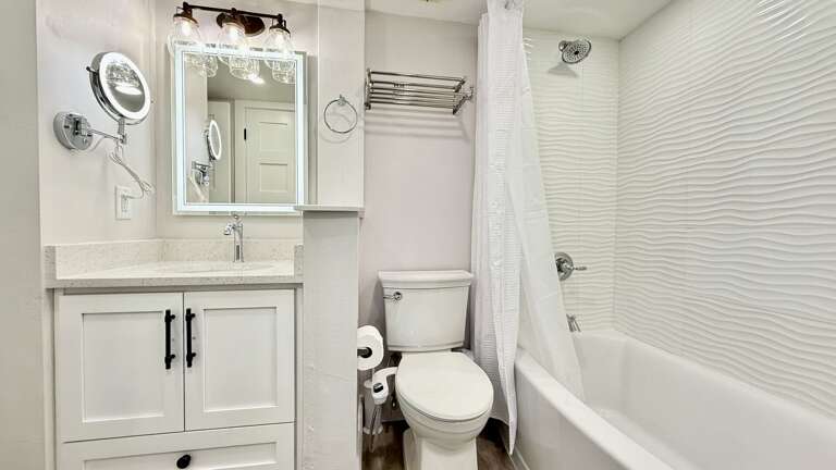 Gorgeous bathroom with luxurious touches, including a full-size and smaller magnifying mirror, both with lighting Gorgeous bathroom with luxurious touches, including a full-size and smaller magnifying mirror, both with lighting