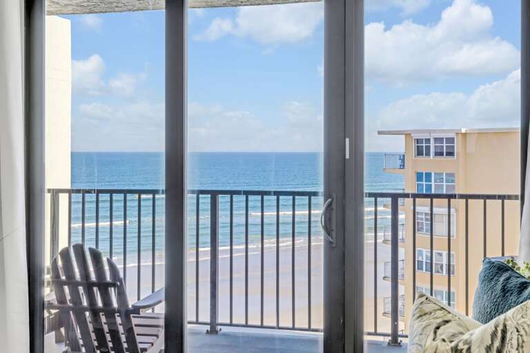 The living room offers stunning ocean views and features a queen memory foam sleeper sofa for your guests