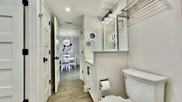 White, updated bathroom with light-up mirrors, offering a luxurious experience White, updated bathroom with light-up mirrors, offering a luxurious experience