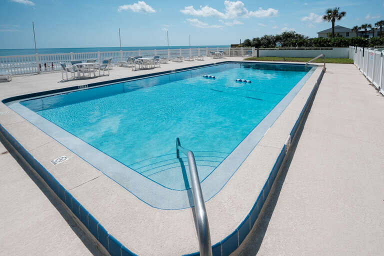 Take a dip in the beachfront pool at Oceanside Village - your perfect spot to relax by the ocean!