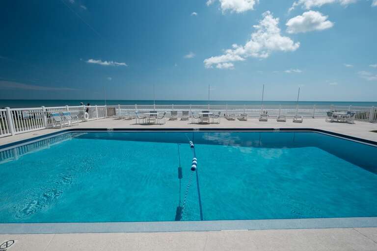 Dive into relaxation at the beachfront pool—your perfect spot to refresh and unwind by the beach!