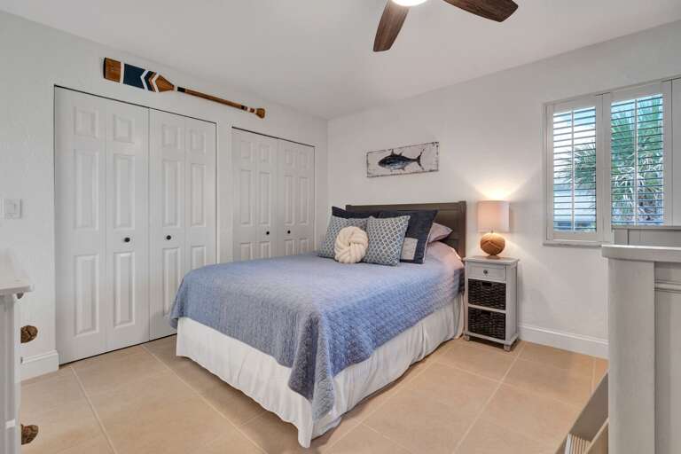 Enjoy a restful night in the guest bedroom, featuring a comfortable queen bed for sweet dreams.