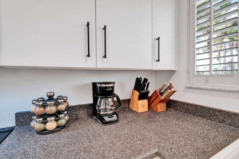 Start your mornings right with a standard drip coffee maker in the kitchen.
