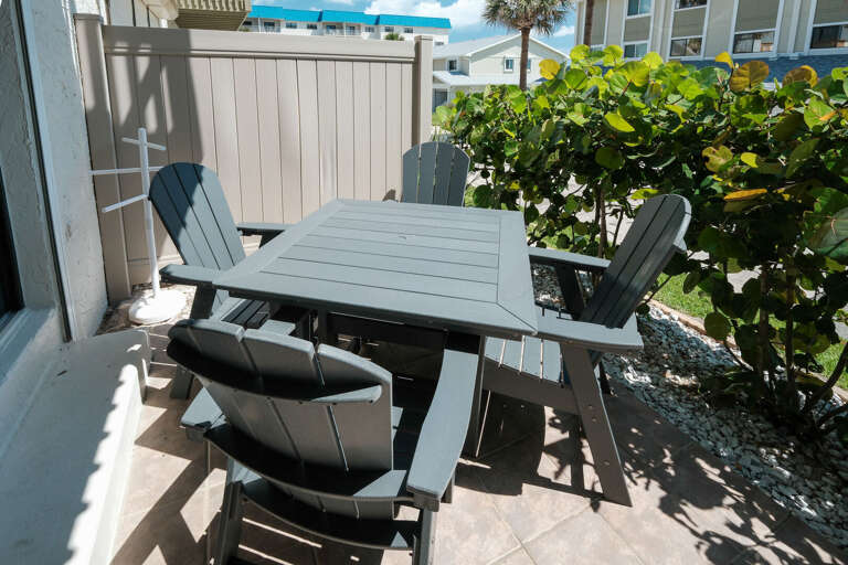 Step out from the living room onto your private patio, complete with a cozy table and chairs for relaxing outdoors.