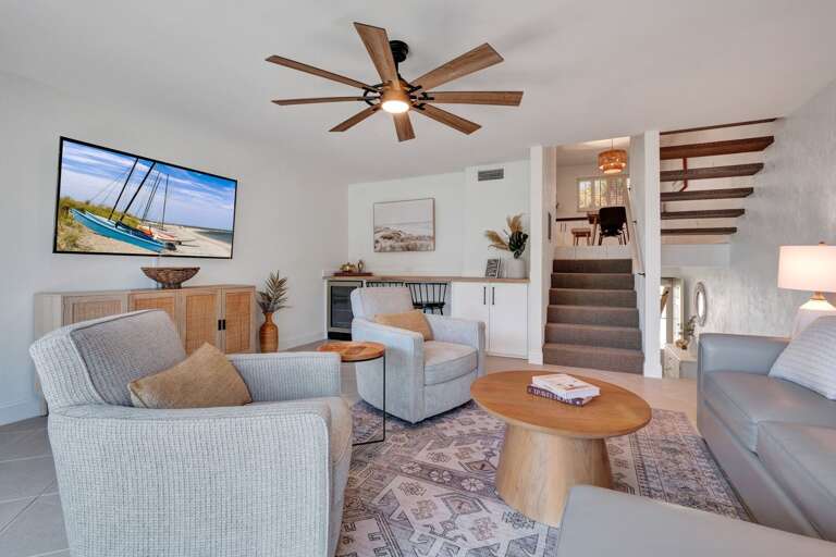 Unwind in the cozy living room featuring beach-inspired décor and a TV for your entertainment!