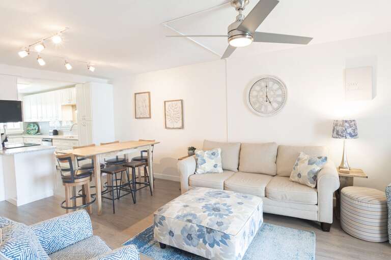 Cozy and comfortable living room, complete with a pool view visible through the sliding glass balcony doors Cozy and comfortable living room, complete with a pool view visible through the sliding glass balcony doors