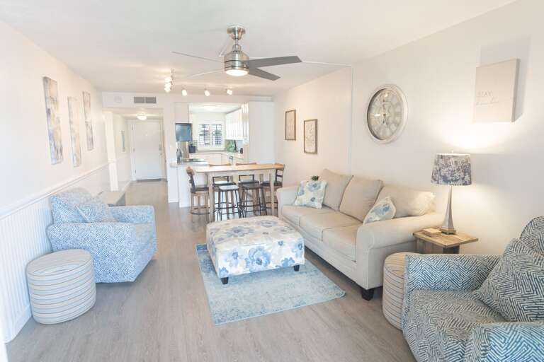 Cozy living room with ample comfortable seating, ideal for relaxation after a day at the beach Cozy living room with ample comfortable seating, ideal for relaxation after a day at the beach