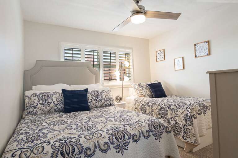 Guest bedroom comfortably sleeps 3 with a queen bed and a twin bed, providing a space for family or friends Guest bedroom comfortably sleeps 3 with a queen bed and a twin bed, providing a space for family or friends
