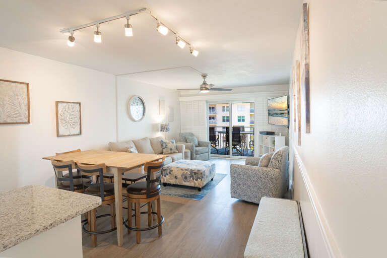 An inviting ocean-view living room and dining area, thoughtfully designed for ultimate comfort and relaxation An inviting ocean-view living room and dining area, thoughtfully designed for ultimate comfort and relaxation