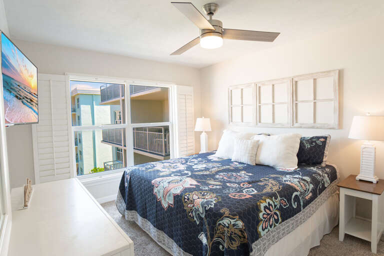 Master bedroom featuring a luxurious king bed and a TV, providing the perfect spot for restful nights after a day of fun in the sun Master bedroom featuring a luxurious king bed and a TV, providing the perfect spot for restful nights after a day of fun in the sun