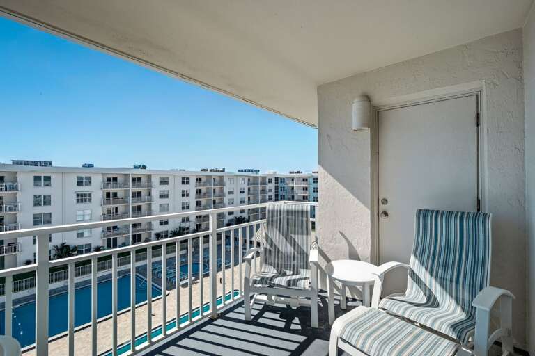 Balcony overlooking the Sea Coast Gardens pool deck Balcony overlooking the Sea Coast Gardens pool deck