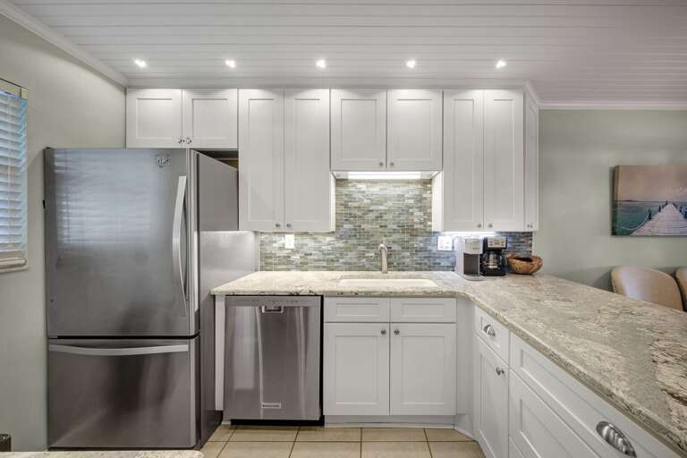This beautifully updated kitchen at Sea Coast Gardens II 508 offers stainless steel appliances and everything you need for a seamless vacation This beautifully updated kitchen at Sea Coast Gardens II 508 offers stainless steel appliances and everything you need for a seamless vacation