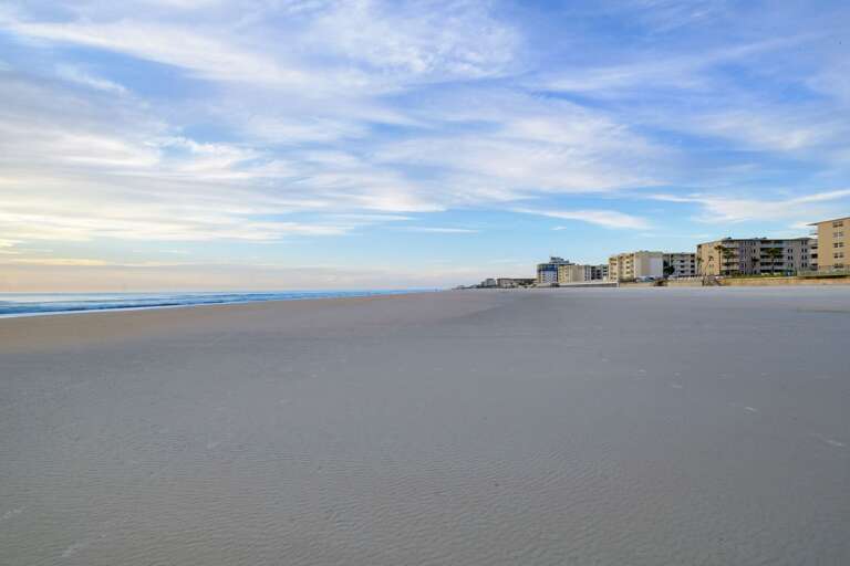 New Smyrna Beach boasts a wide, flat shoreline, perfect for long walks, beach games, and soaking up the sun New Smyrna Beach boasts a wide, flat shoreline, perfect for long walks, beach games, and soaking up the sun
