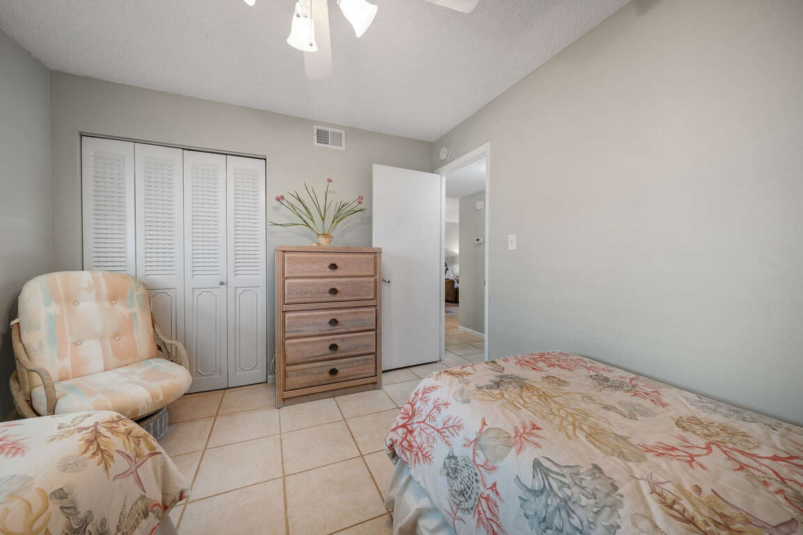 The guest bedroom features a dresser and convenient closet for storing clothes and luggage The guest bedroom features a dresser and convenient closet for storing clothes and luggage