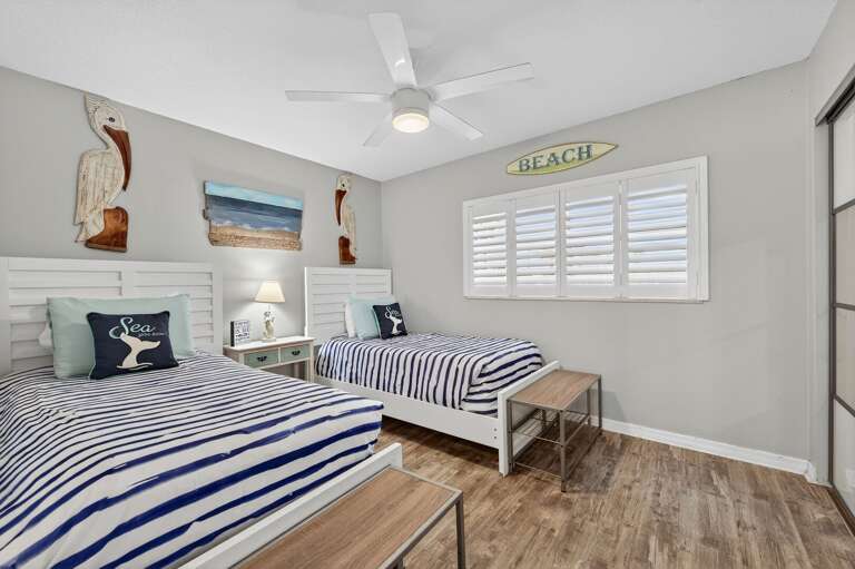 Bright and airy guest bedroom sleeps 4 with two twin beds.