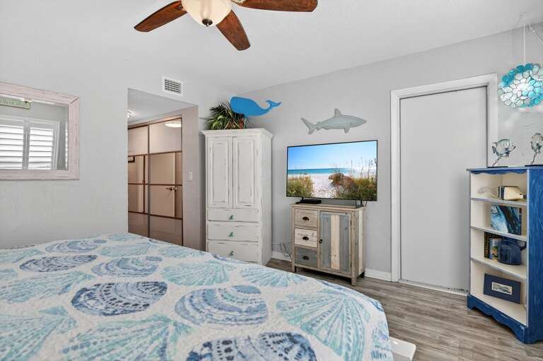 Relax in the king-sized master bedroom with a TV and serene beach views that set the perfect coastal vibe.
