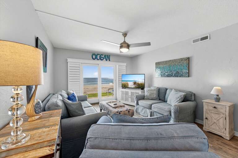 Relax in the oceanfront living room with stunning, uninterrupted views just beyond your patio. Relax in the oceanfront living room with stunning, uninterrupted views just beyond your patio.