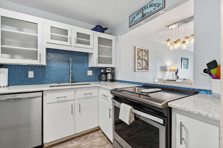 Whip up coastal favorites in the modern, fully equipped kitchen featuring sleek stainless steel appliances.