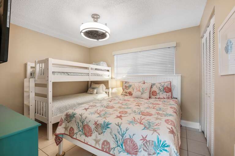 Comfortably sleep 4 in the guest bedroom, featuring a cozy queen bed and a twin bunk bed Comfortably sleep 4 in the guest bedroom, featuring a cozy queen bed and a twin bunk bed